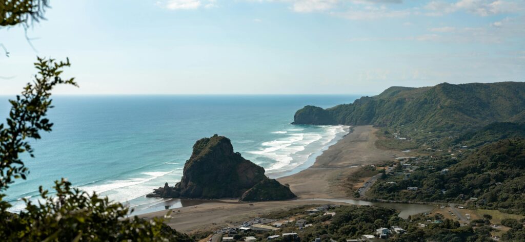 Explore the breathtaking aerial view of Piha Beach, showcasing the natural beauty of New Zealand's coastline.