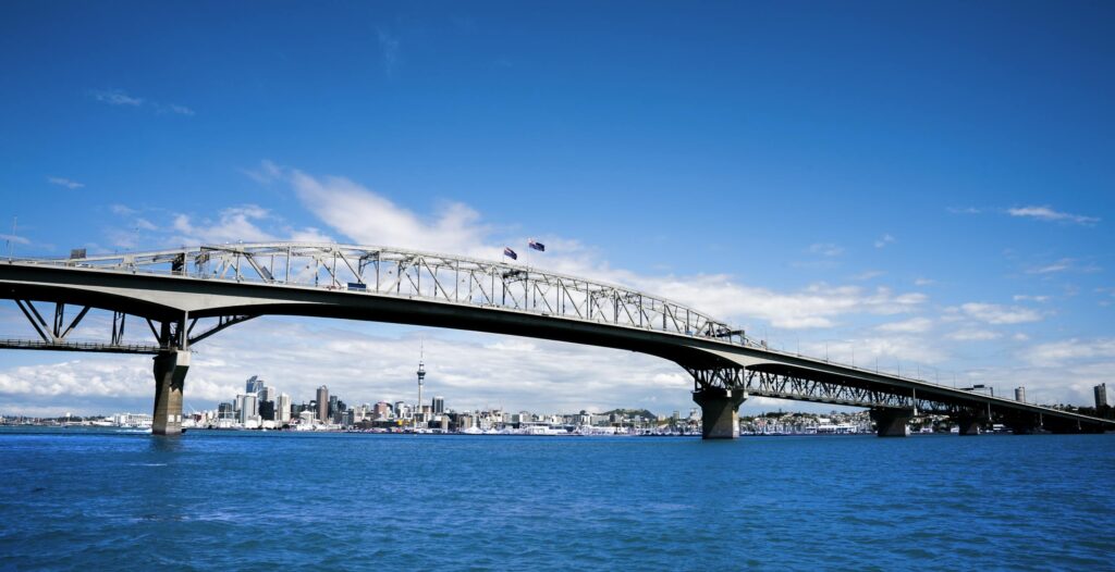 Stunning view of Auckland Harbour Bridge with vibrant sky and skyline in background.