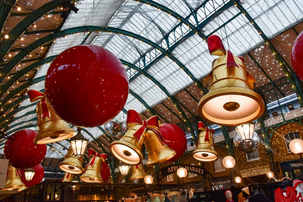 Christmas decorations at Covent Garden Market in London with large ornaments and festive lights.
